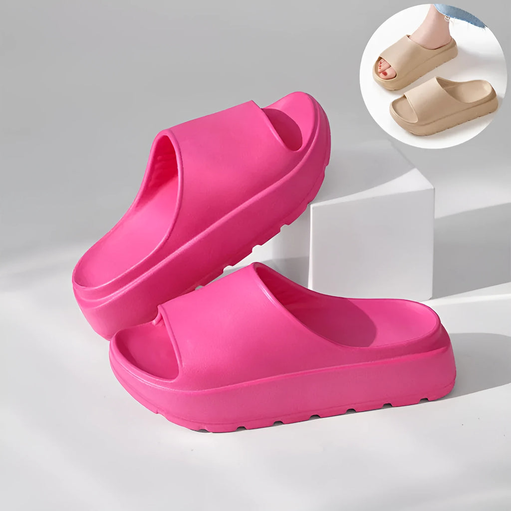 Women's beige fish mouth style slippers with a thick EVA sole on a wooden floor.