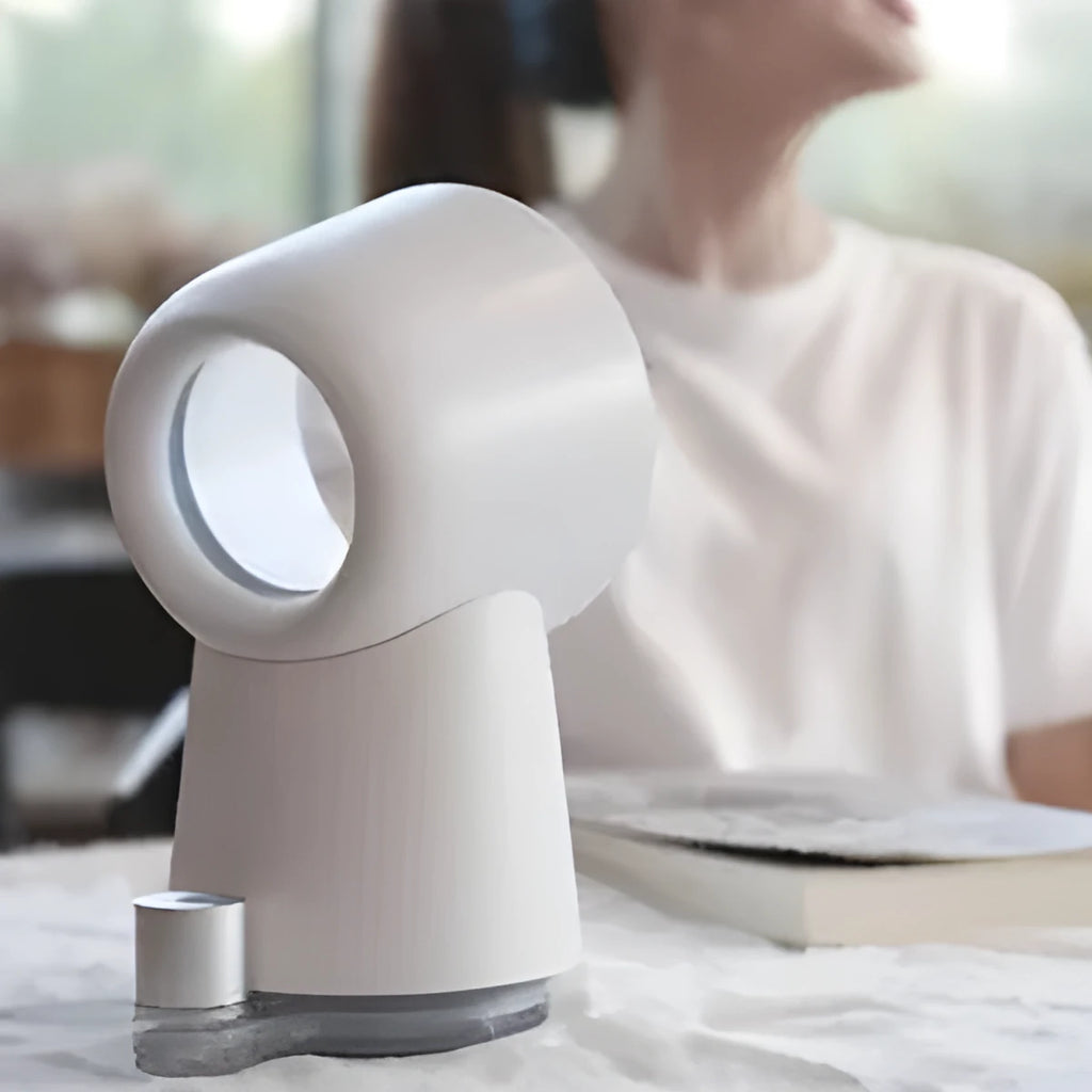 White desktop bladeless fan with USB power and humidification spray on a desk