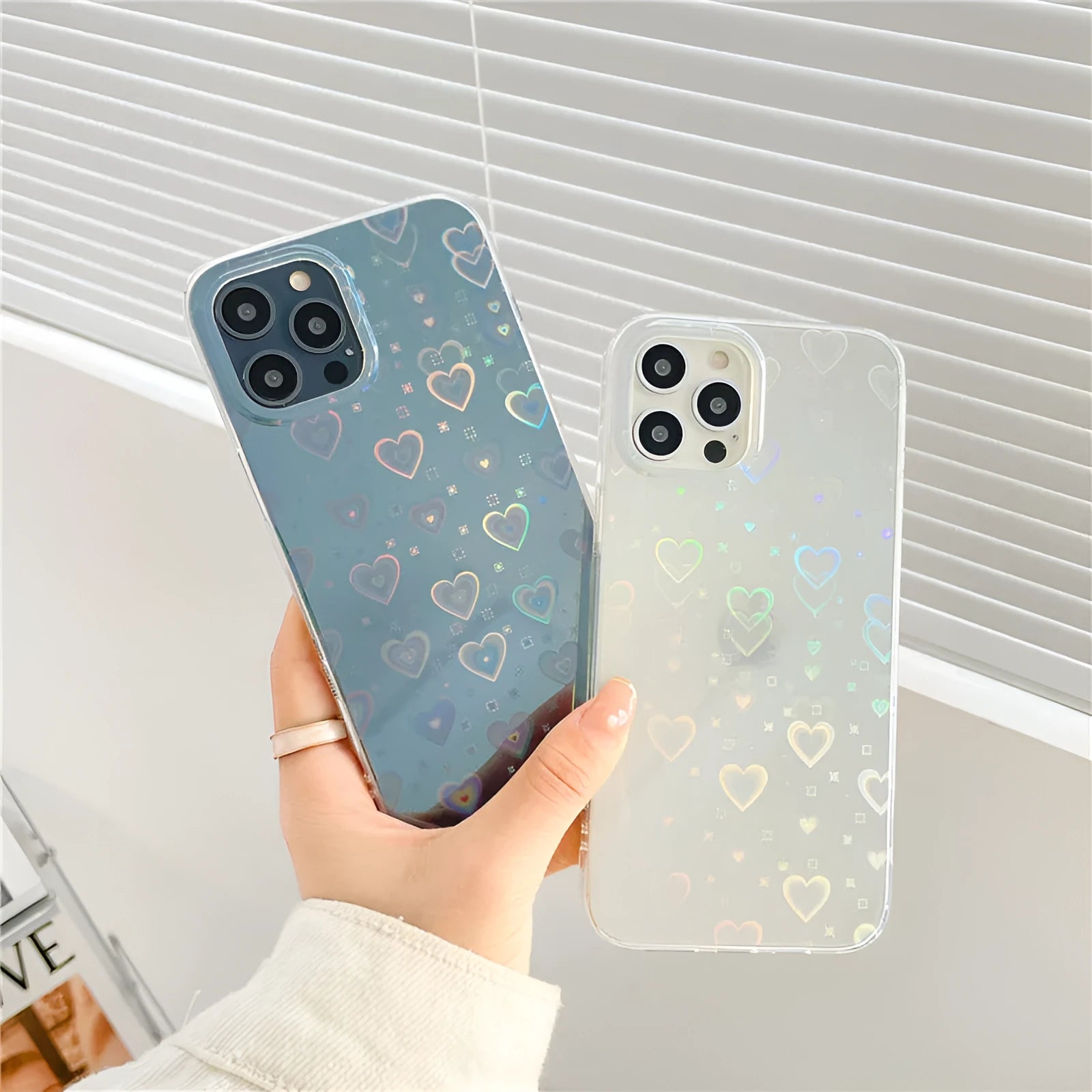 Transparent silicone iPhone case with a laser-etched love heart design on the back.