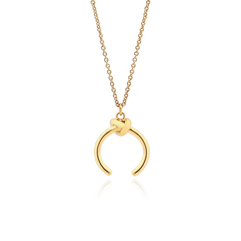 Geometric copper pendant necklace on an adjustable cross chain in a gold electroplated finish.