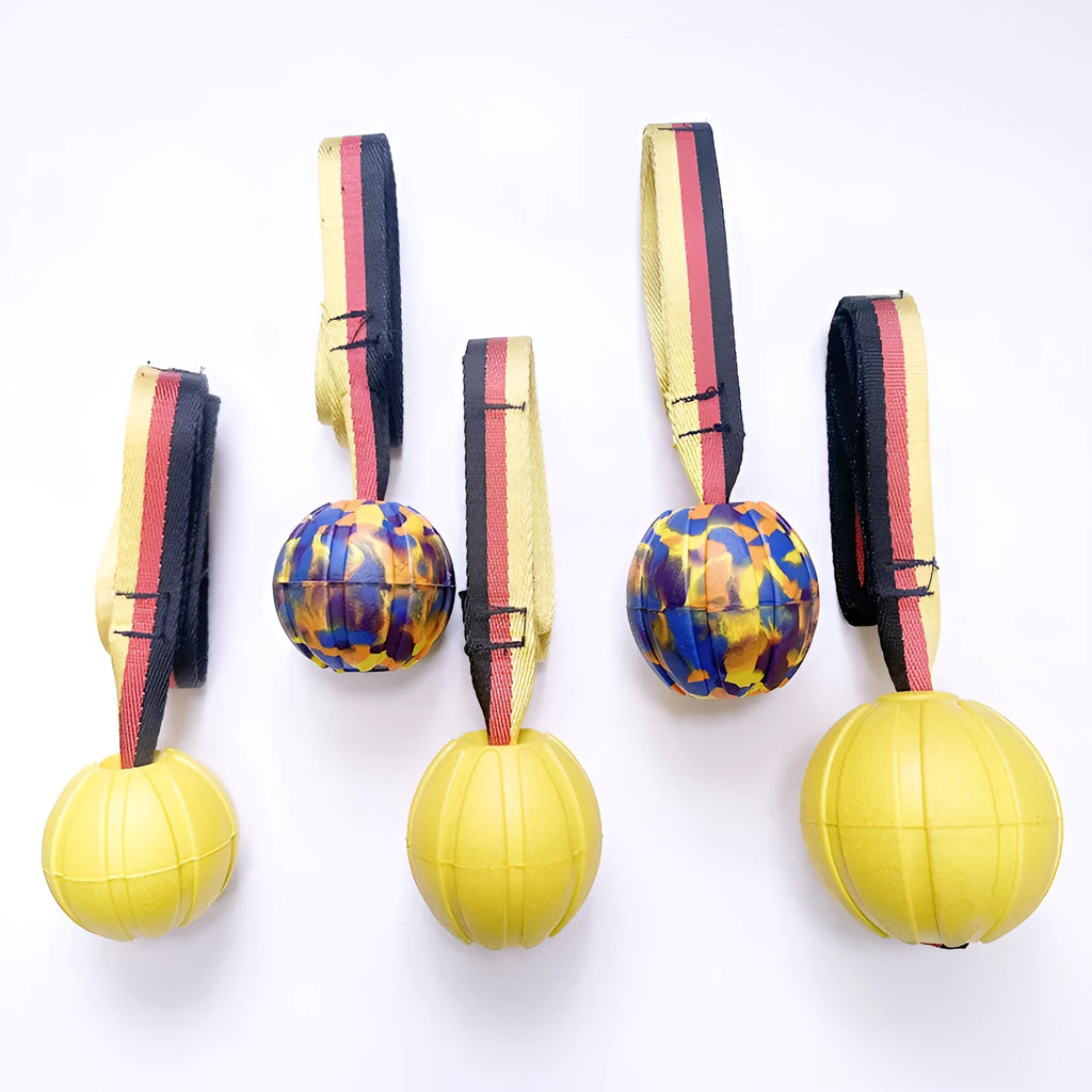 Floating EVA foam dog training ball with string in camouflage or yellow colour, shown in 6.5cm, 7cm, and 9cm diameter sizes