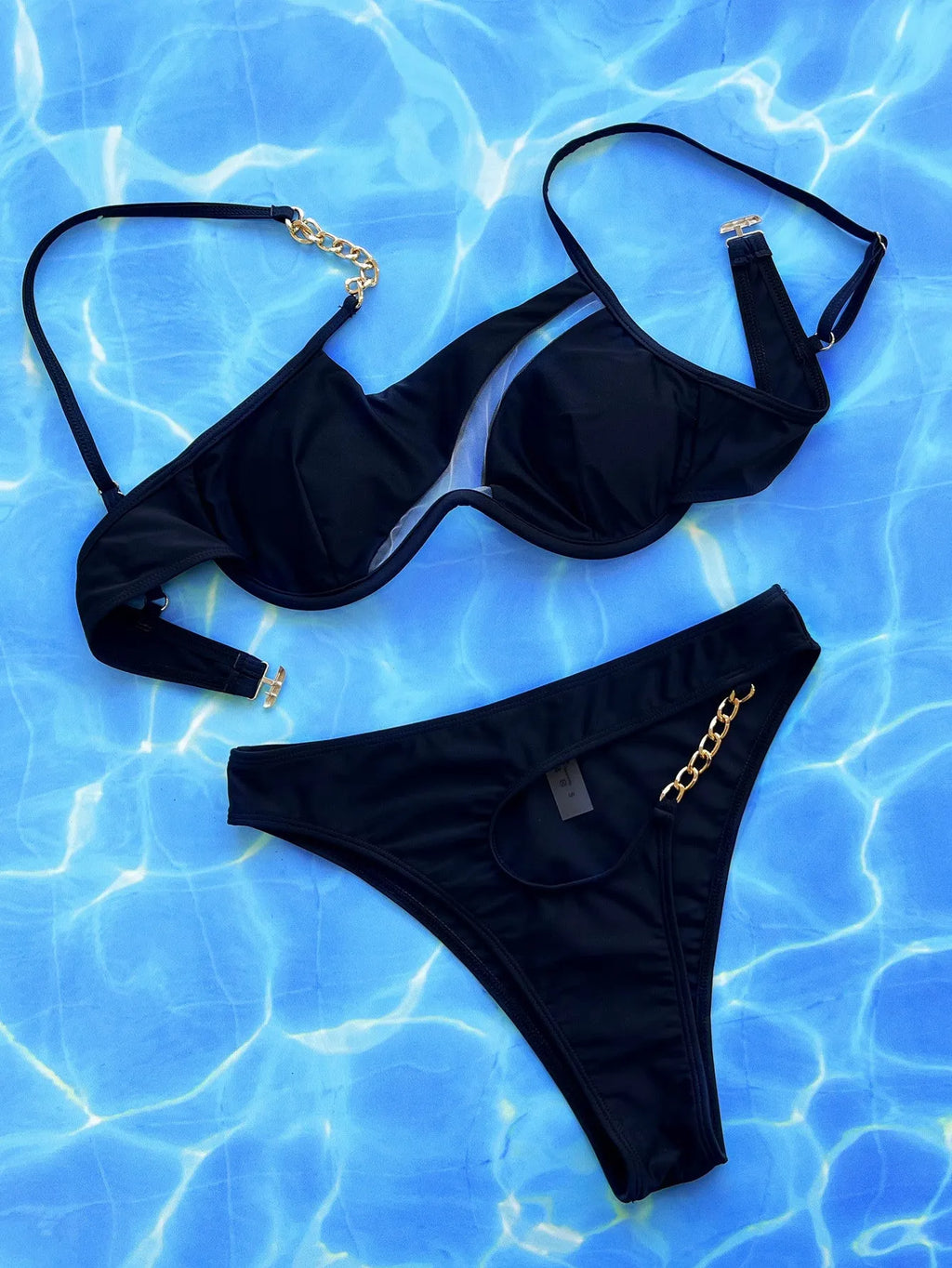 Black women's one-piece swimsuit with a hollow split design, made from nylon fabric.