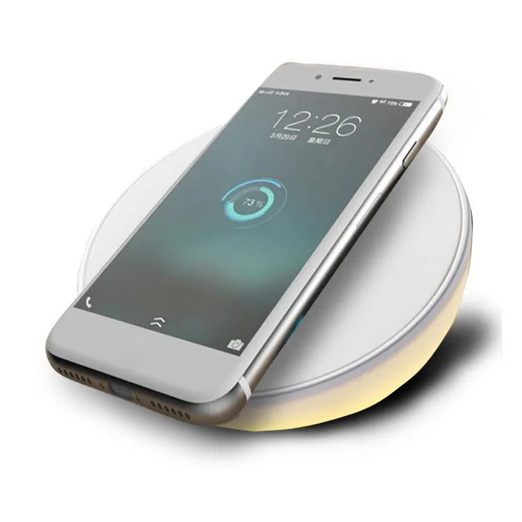 White wireless charging pad with clock display and control buttons for smartphone charging