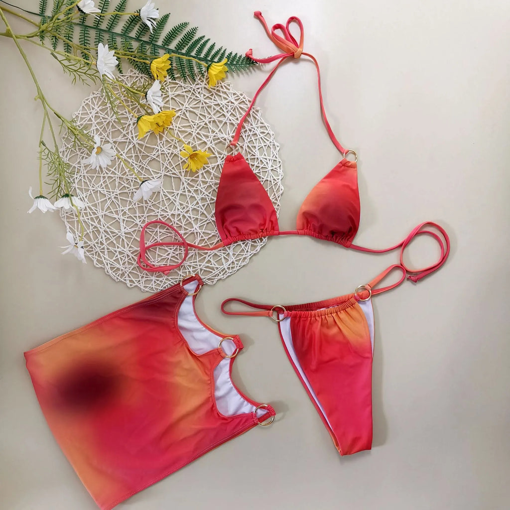 Tie-dye pattern halterneck bikini three-piece set with matching skirt on a mannequin.