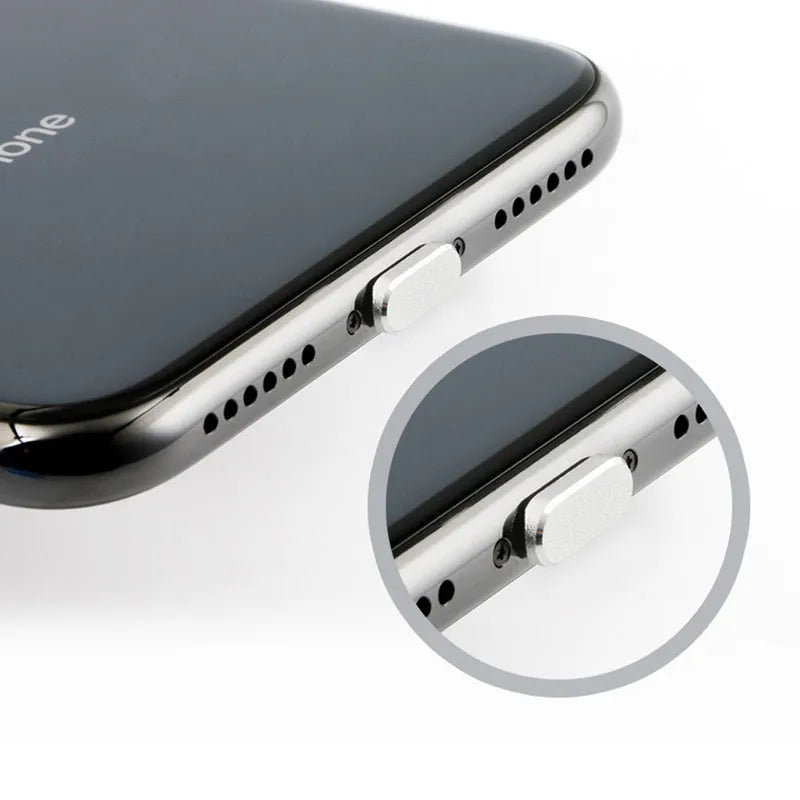 Aluminum alloy iPhone charging port dust plug in rose gold colour on a grey background.