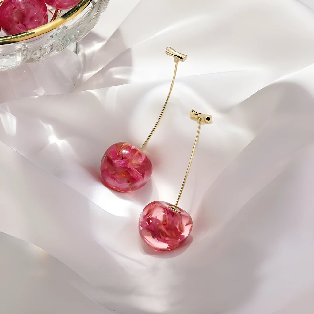 Long red French dried cherry earrings for women in plated alloy design on white background