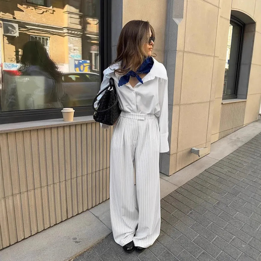 White striped loose fit wide-leg casual trousers with a zipper, shown on a hanger.