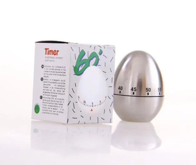 Egg-shaped stainless steel mechanical kitchen timer on a kitchen countertop.