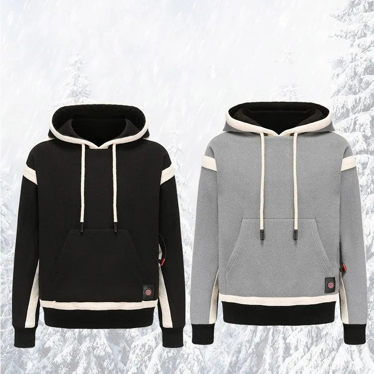 Women's USB heated jacket hoody in black, with brushed fabric and knitted construction, shown outdoors in cold weather