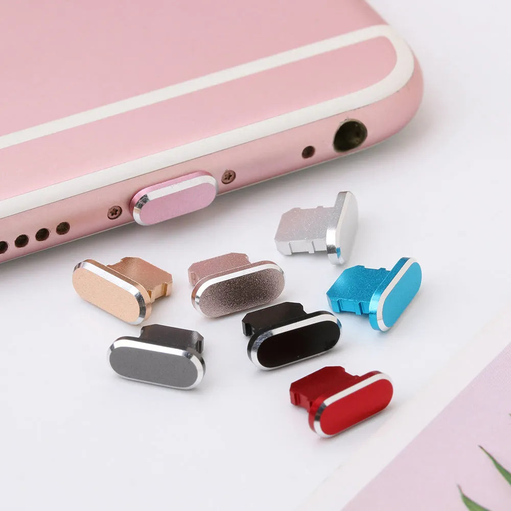 Aluminum alloy iPhone charging port dust plug in rose gold colour on a grey background.