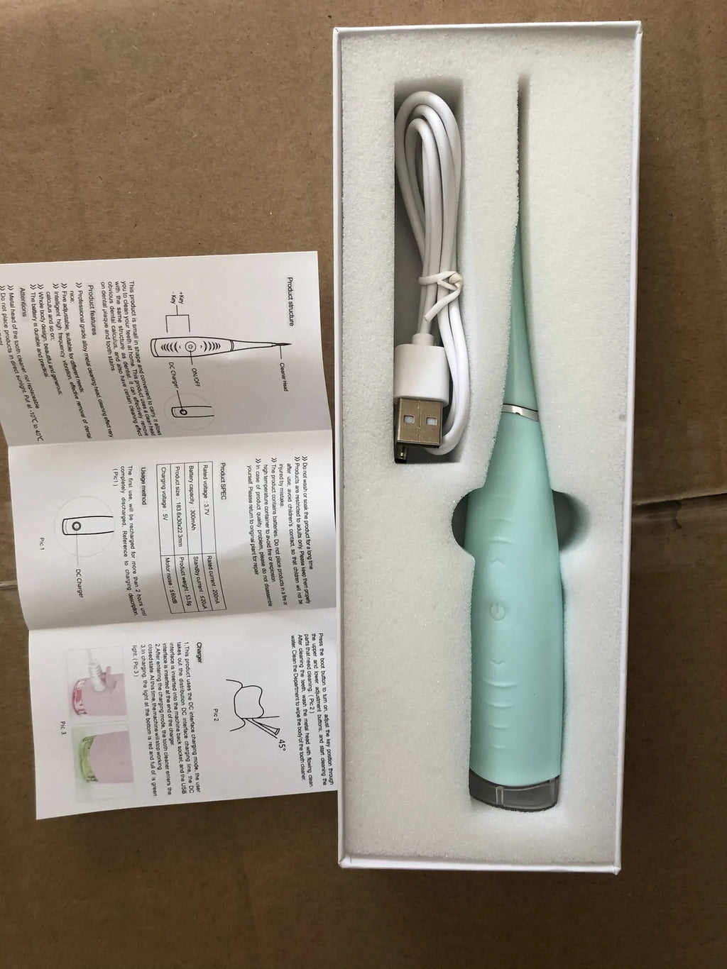 Pink and blue waterproof electric dental calculus remover tool on a white background