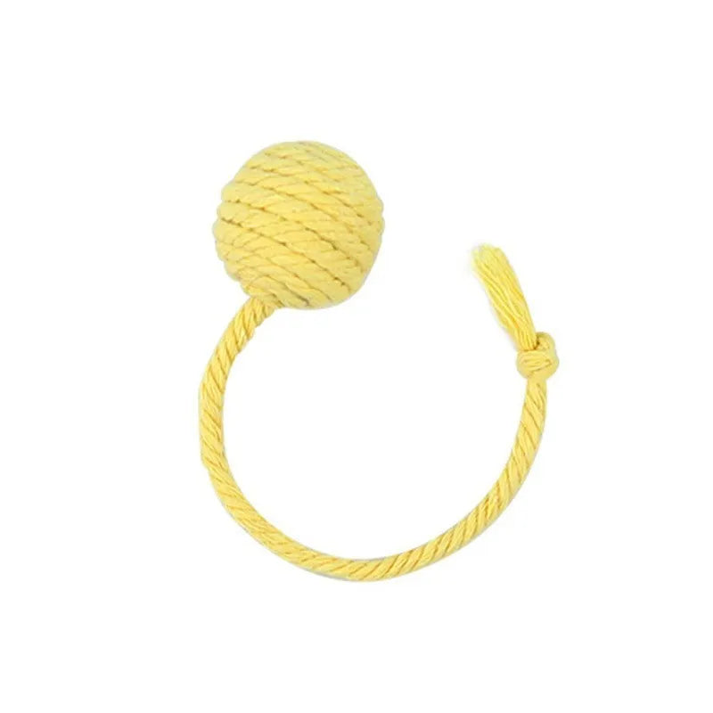 Colourful cat toy ball with an attached rope and built-in bell for kittens, shown in green, pink, purple, and yellow.