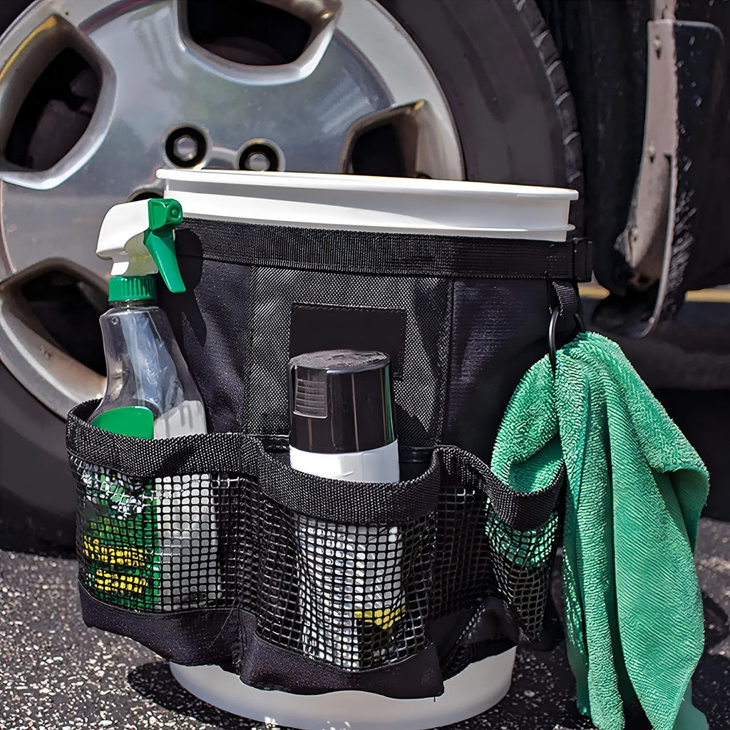 Black cylindrical polyester storage bag hanging on a 5-gallon bucket for organising tools.
