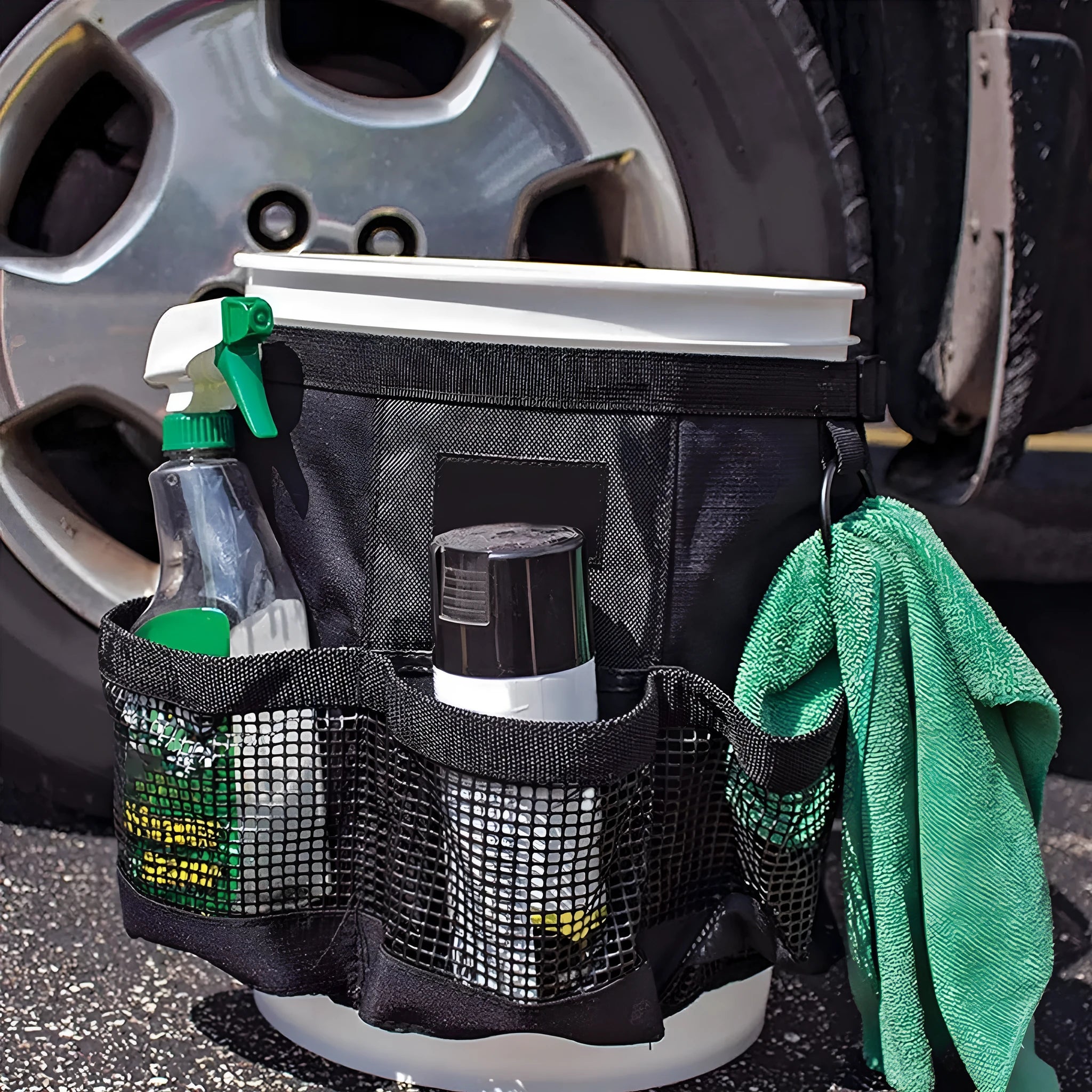 Black cylindrical polyester storage bag hanging on a 5-gallon bucket for organising tools.