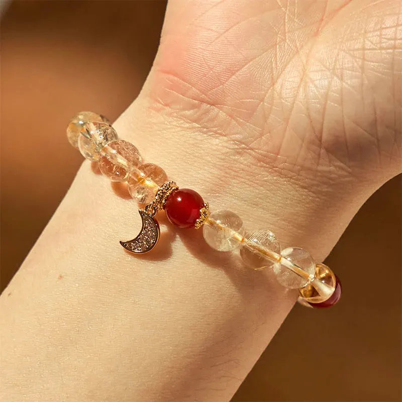 Women's handmade crystal bracelet featuring citrine and red agate beads in a moon boom style.