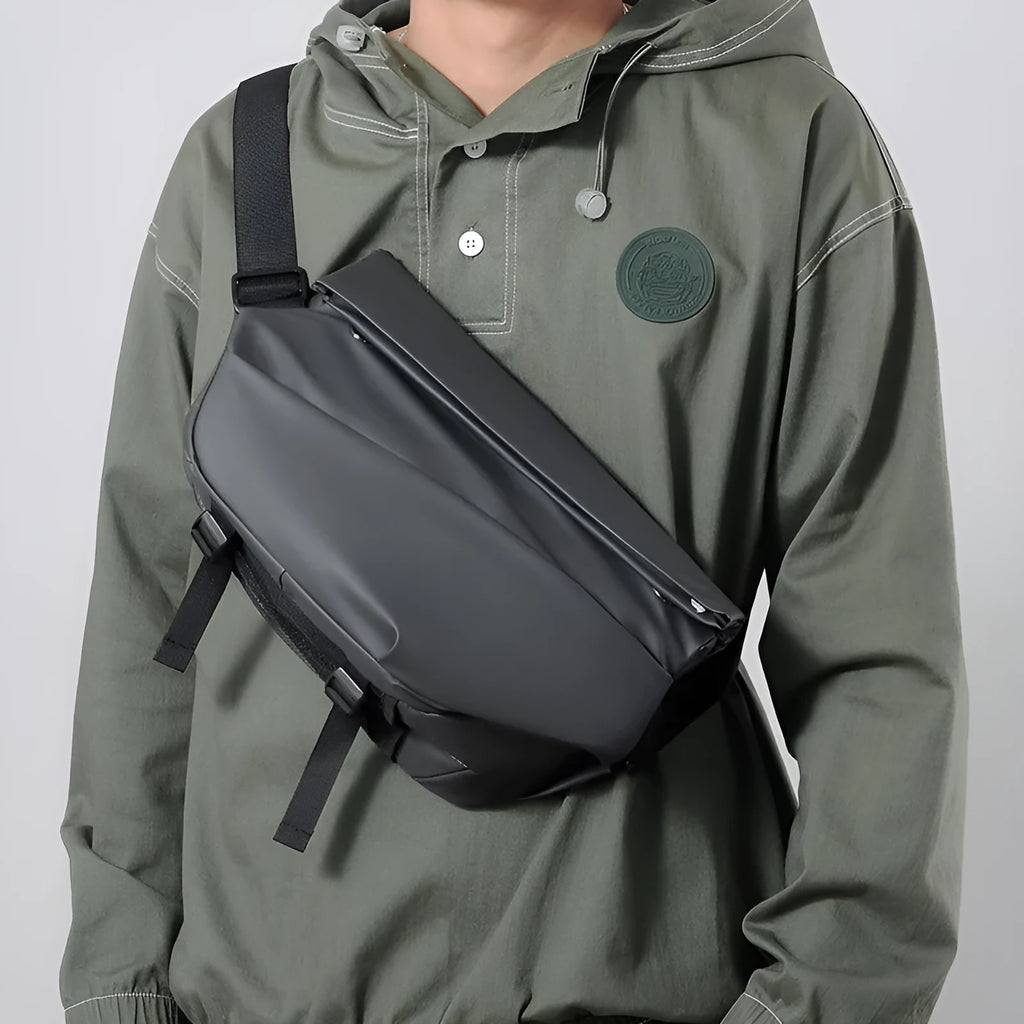 Grey horizontal square men's crossbody bag made of PU leather with a zipper and shoulder strap.
