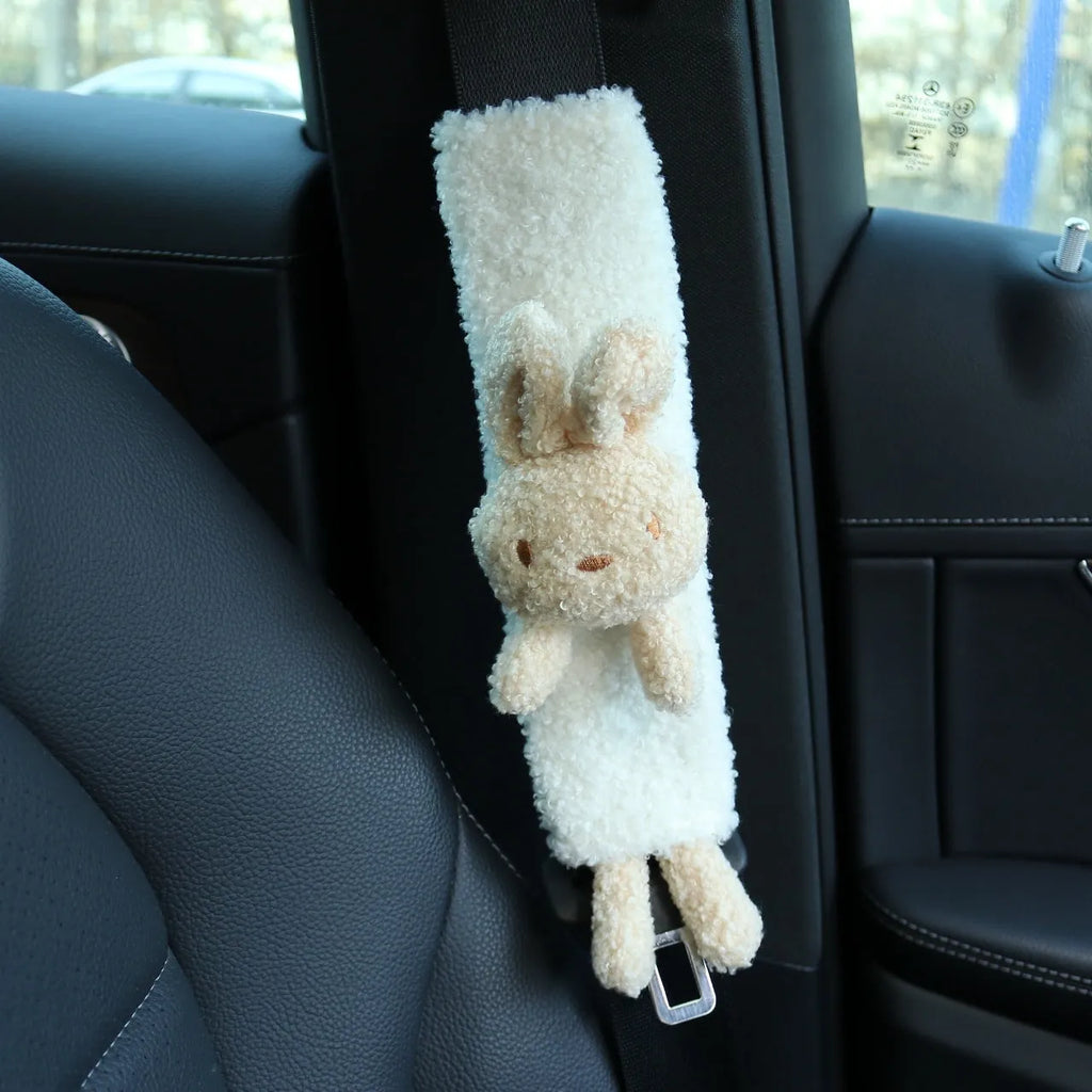 Cartoon plush car seat belt shoulder protector in lamb wool, showing rabbit and bear designs.