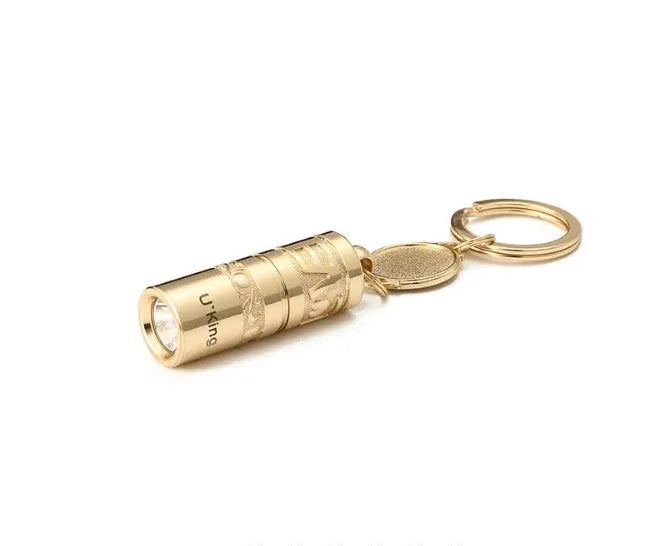 Gold-coloured zinc alloy die-cast LED keychain flashlight with attached key ring.