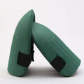 A pair of simple EVA foam knee pads in an army green colour, showing their rectangular shape and thickness.