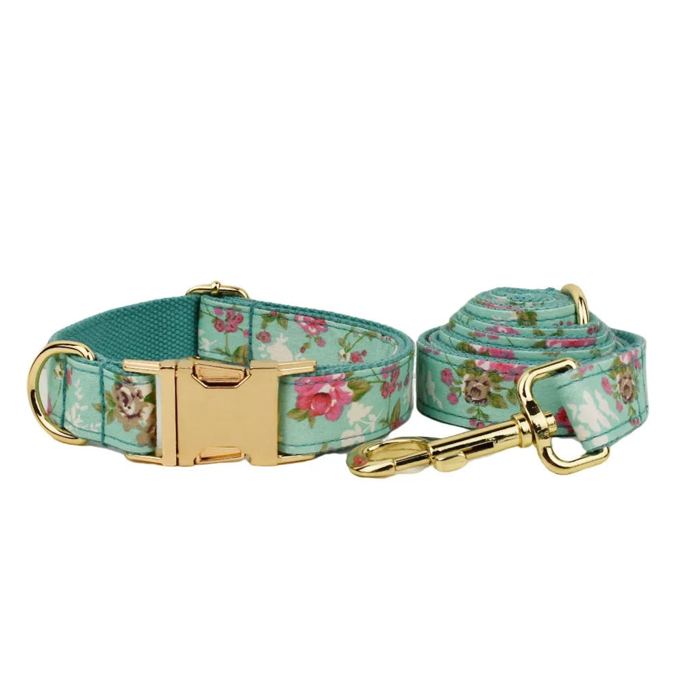 Rose-coloured fabric dog collar set with green background, includes leash, detachable bow, and vest for dogs.