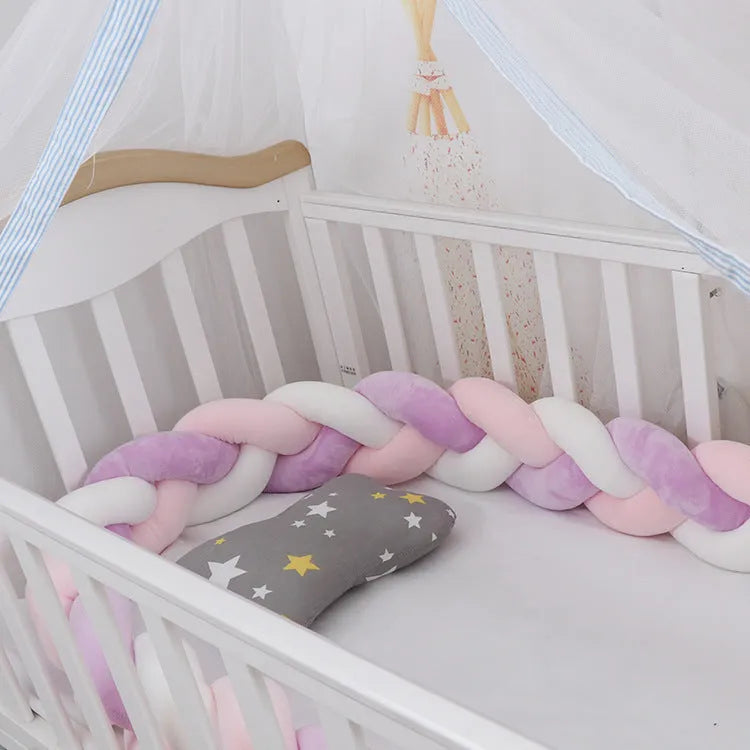 Baby crib bumper protector in spandex velvet, bent to show flexible shape, against a crib rail.