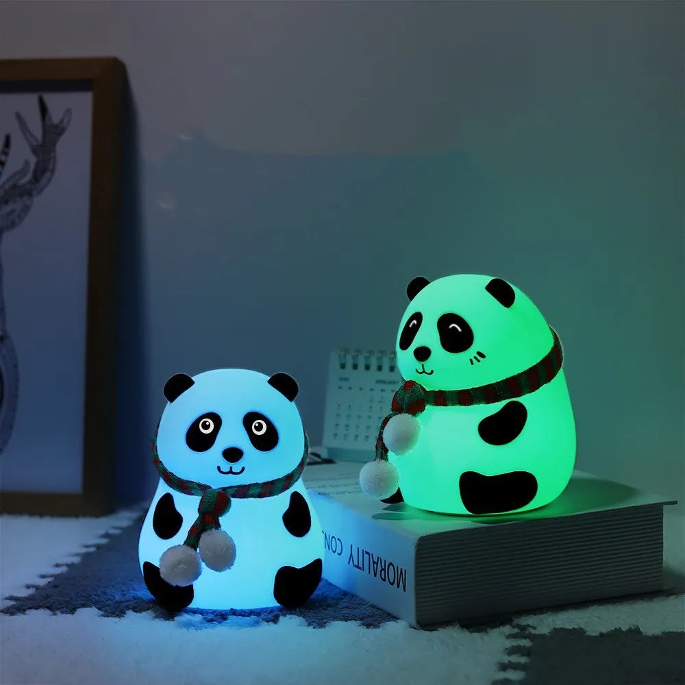 White panda-shaped silicone night light with black accents, showing its compact size and soft LED glow.