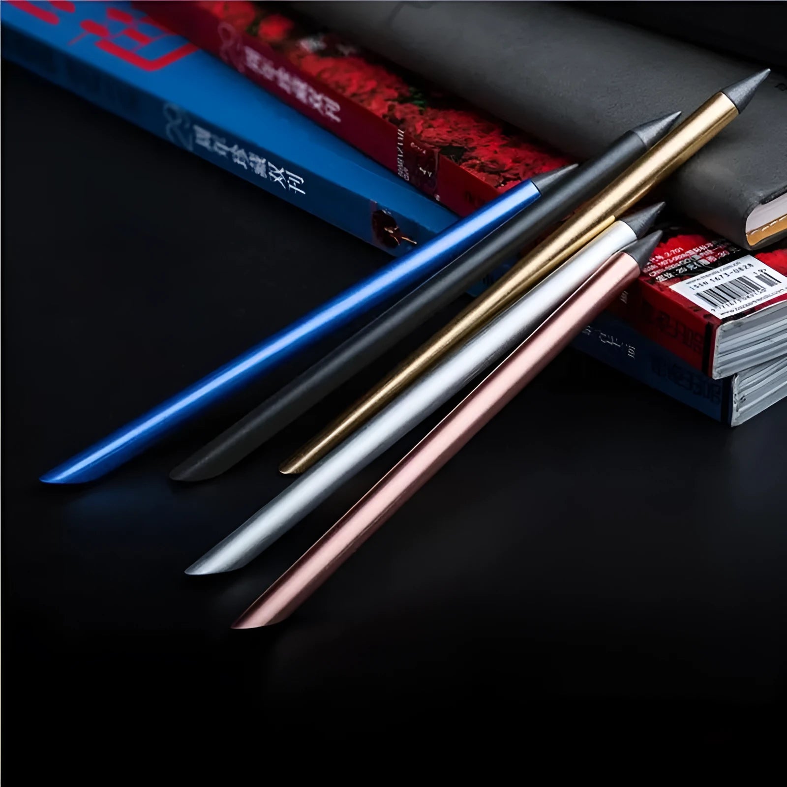 Silver inkless metal pen with alloy nib next to its storage box and spare nib.