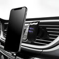 Black car phone holder mounted on vehicle air vent showing smartphone placement