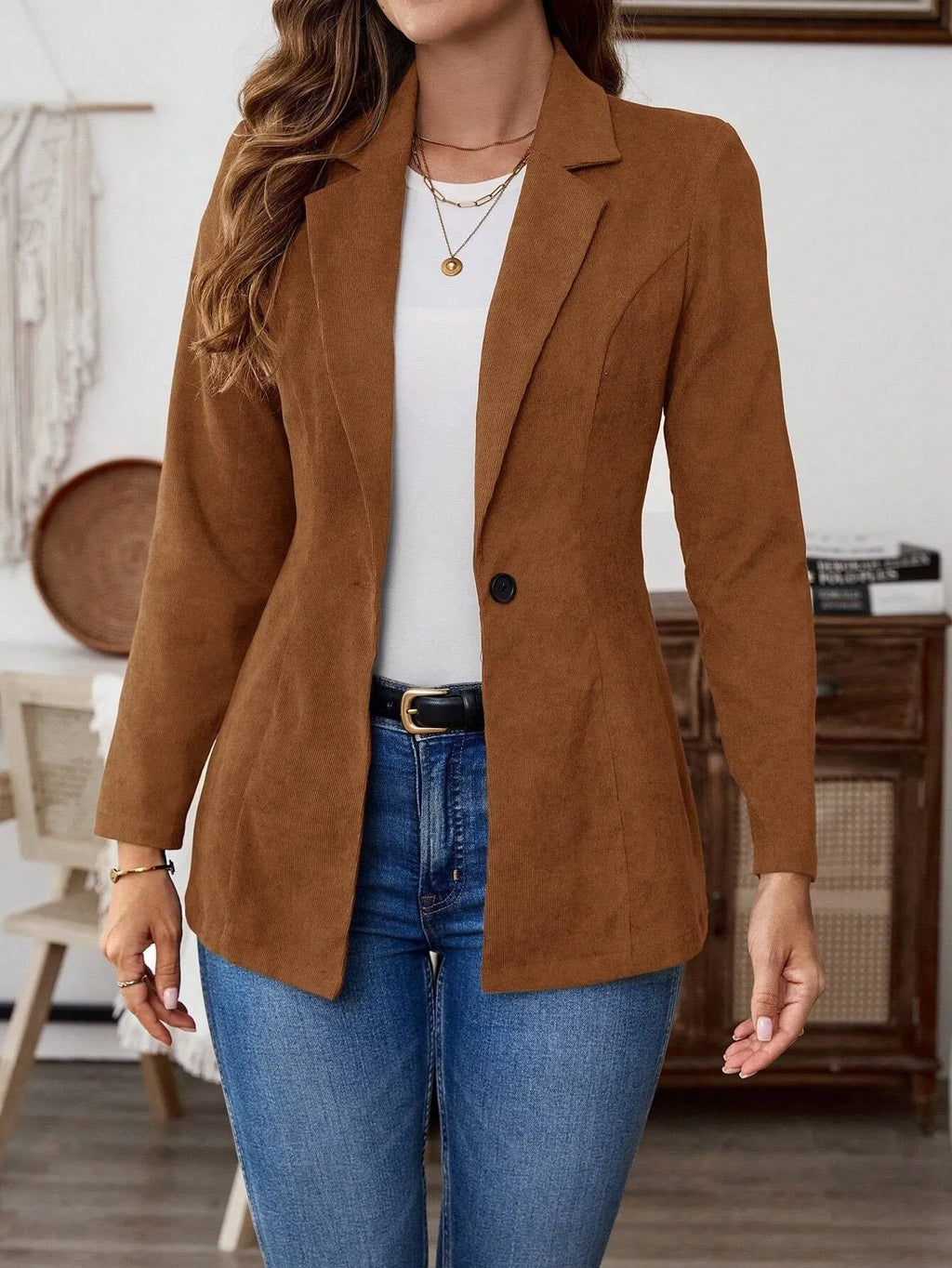 Brown men's single-breasted casual suit coat with long sleeves on a hanger