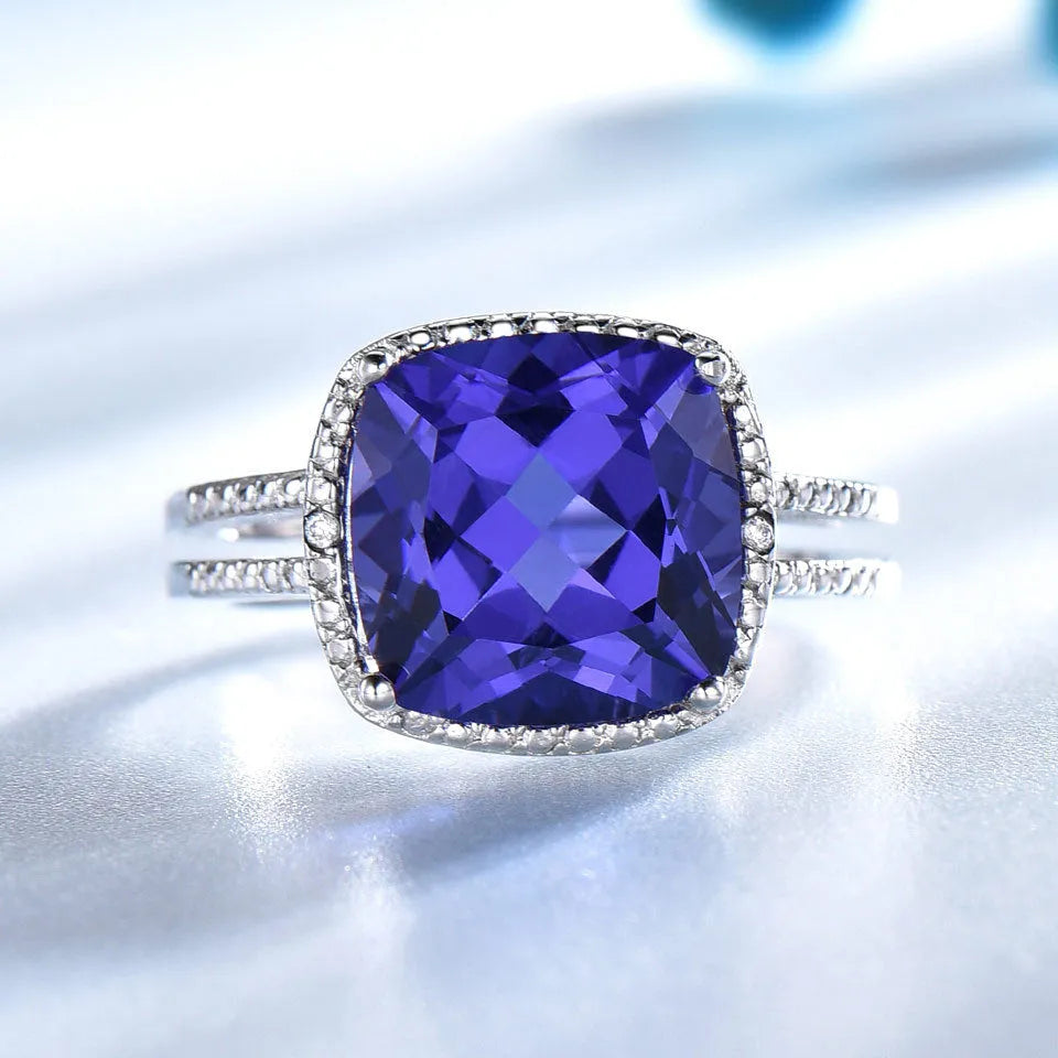 Close-up of a women's sterling silver ring with a blue tanzanite gemstone.