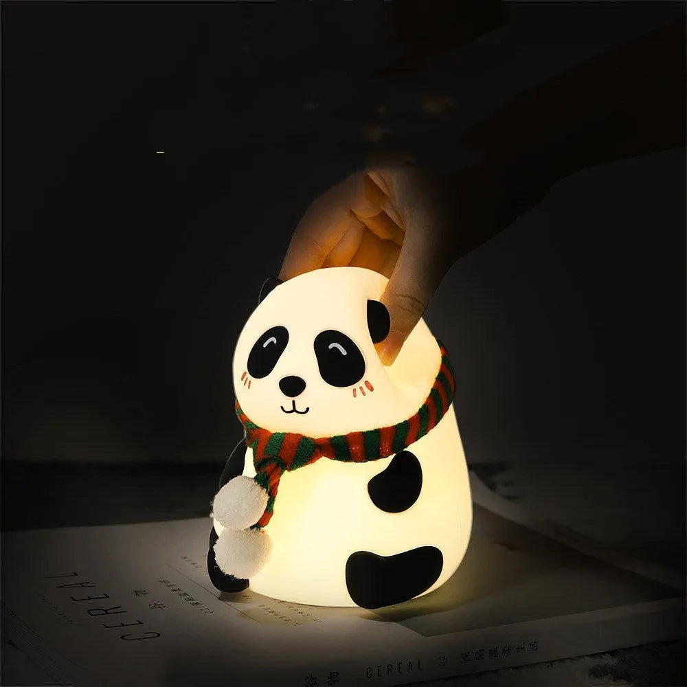 White panda-shaped silicone night light with black accents, showing its compact size and soft LED glow.