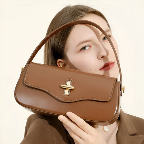 Genuine leather baguette handbag in caramel colour with clamshell design and shoulder straps
