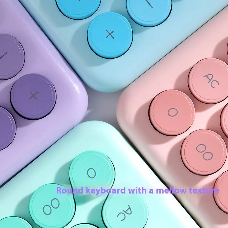 Gradient colour desk calculator in violet, pink, blue, or mint green on a desk.