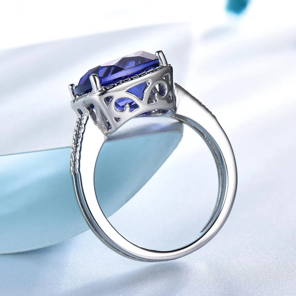 Close-up of a women's sterling silver ring with a blue tanzanite gemstone.