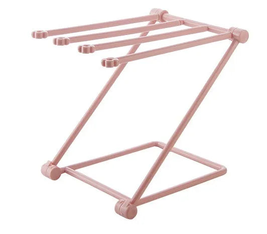 Light grey foldable plastic dishcloth shelf on a kitchen countertop