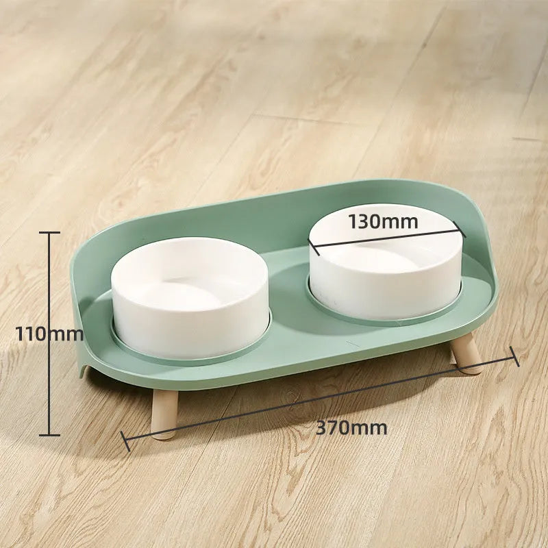Green adjustable tilted double pet food bowl with spill-proof edges for cat and dog feeding