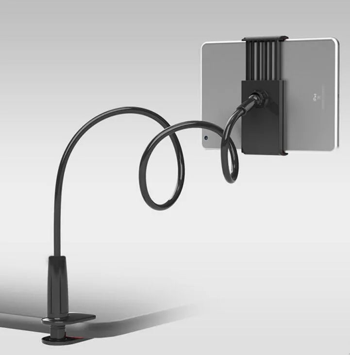 Black bedside oversize flat panel phone holder with long flexible arm mounted on a wooden table.