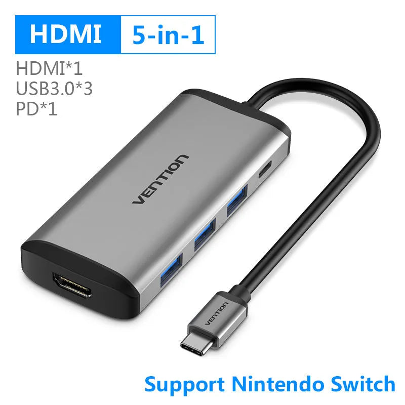 Deep grey USB-C to HDMI, Ethernet, and USB 3.0 multi-port hub on a desk.