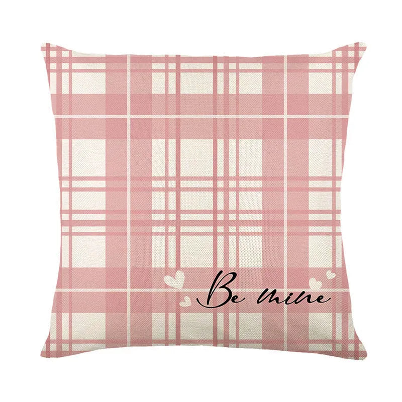 A square Valentine's Day cushion cover with a red and white plaid and heart print design.
