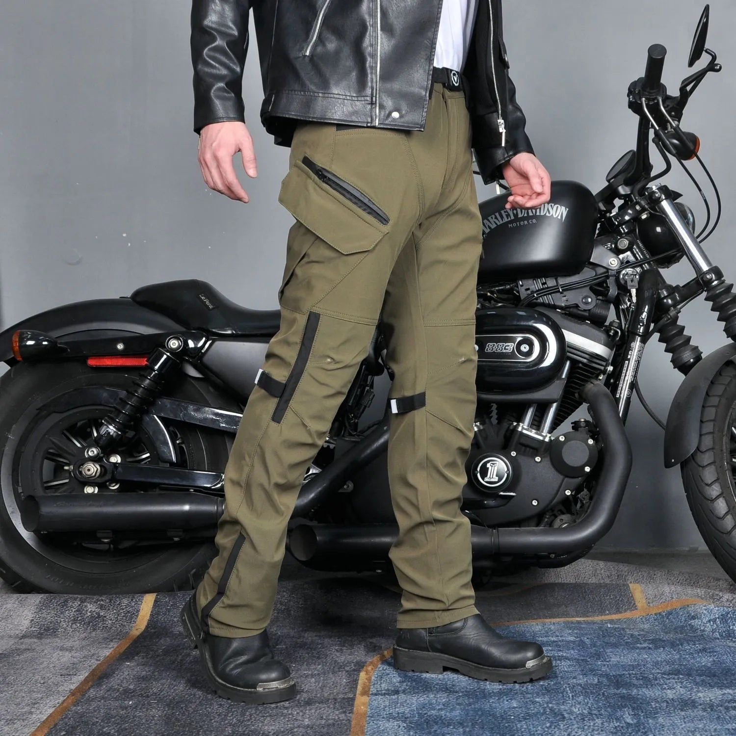 Men's solid-colour waterproof motorcycle trousers shown with a detachable belt and protective knee pads.