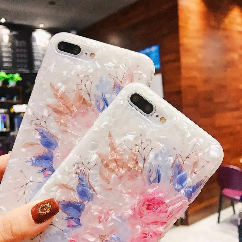 Dream Shell soft TPU iPhone case with rose flower design in brown, shown on an iPhone.