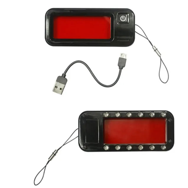 Small red reverse camera detector unit with a scanner window for detecting hidden surveillance lenses.