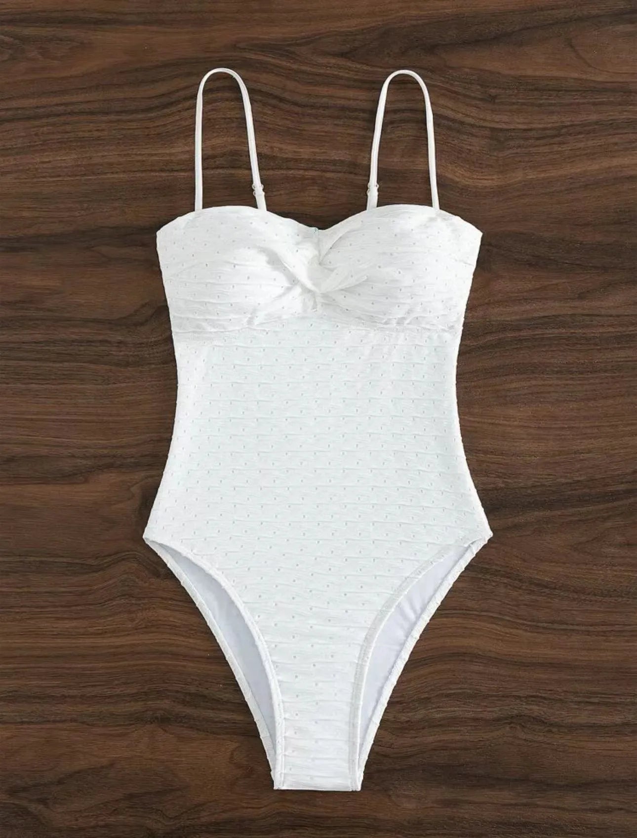 White women's one-piece swimsuit with a sling-style design made from high-elasticity polyester fabric.