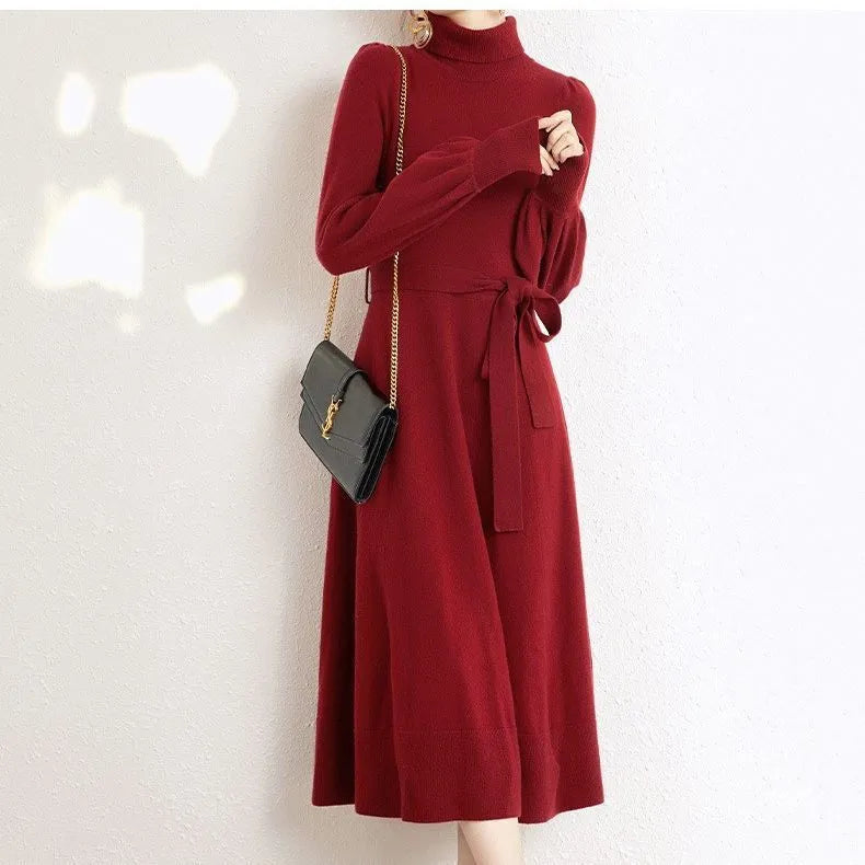 Rose red turtleneck knit dress with long sleeves, elastic waist, and a flared midi-length skirt.