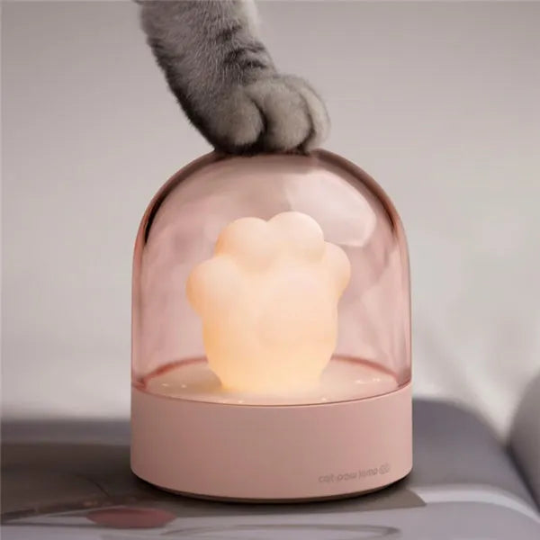 Grey cat paw shaped USB rechargeable night light with musical features on wooden desk
