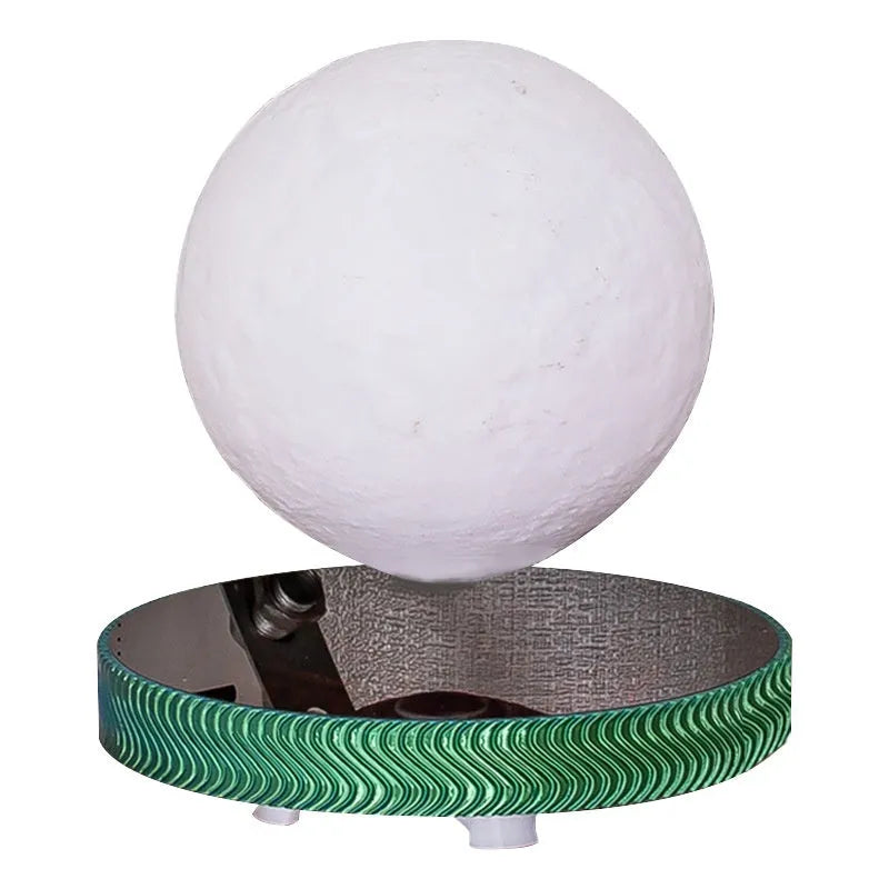 Small magnetic levitating moon lamp floating above its base on a table