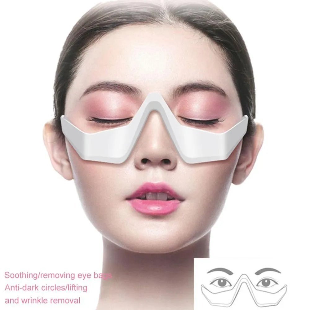 Pink and white 3D micro-current eye massager shaped like glasses on a grey background.