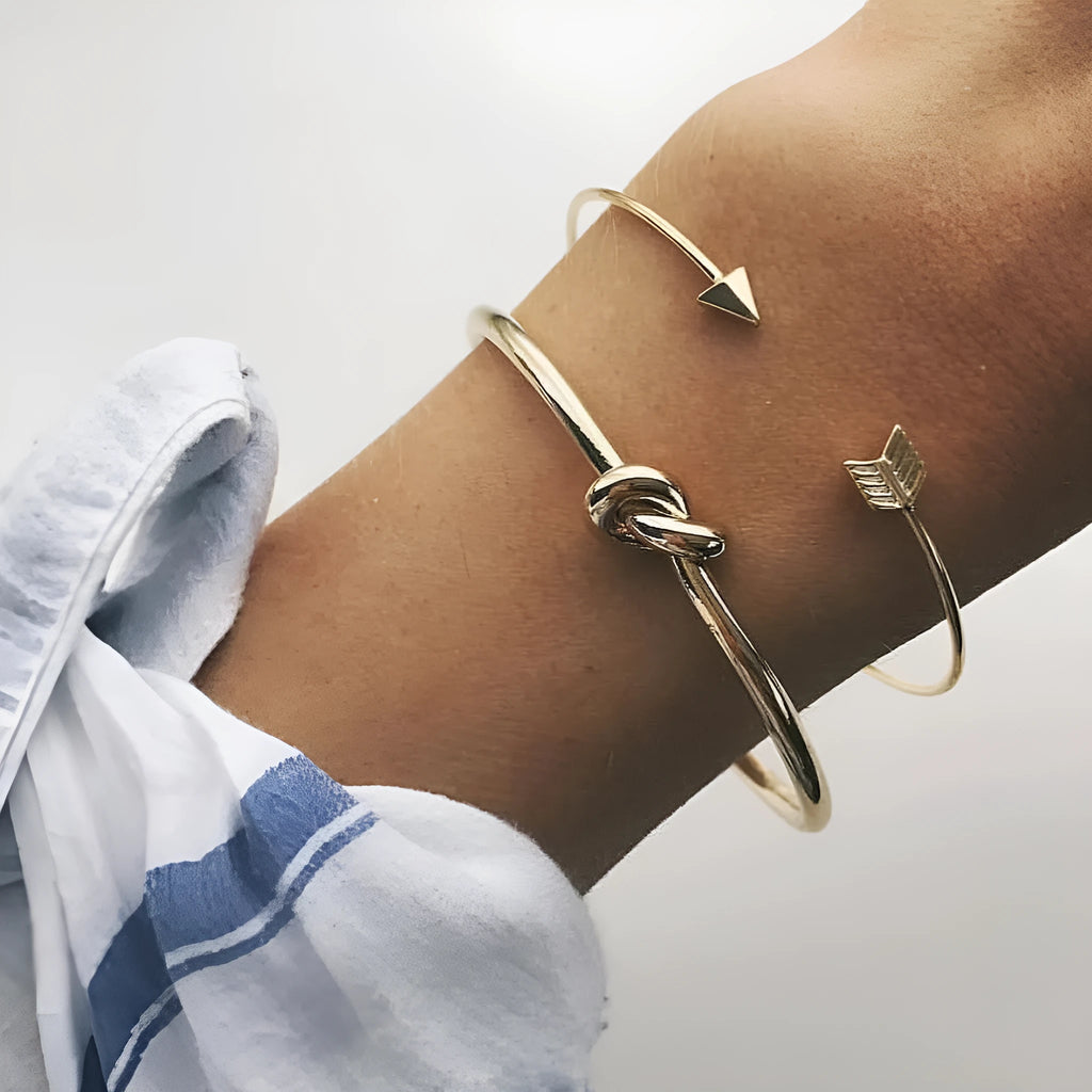 Gold vintage cuff bracelet for women with an arrow design and knotted detail.
