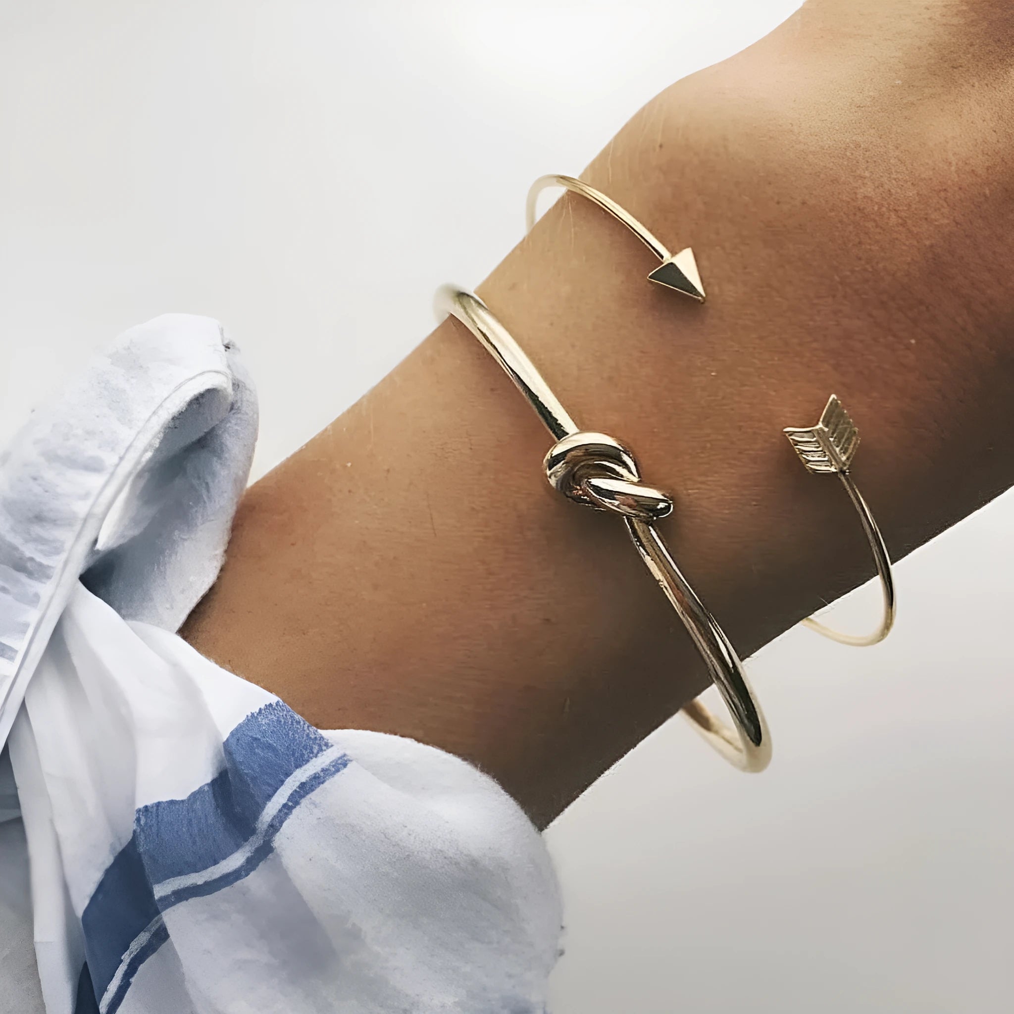 Gold vintage cuff bracelet for women with an arrow design and knotted detail.
