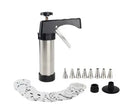 Stainless steel biscuit press gun with set of cookie moulds and piping nozzles on baking tray